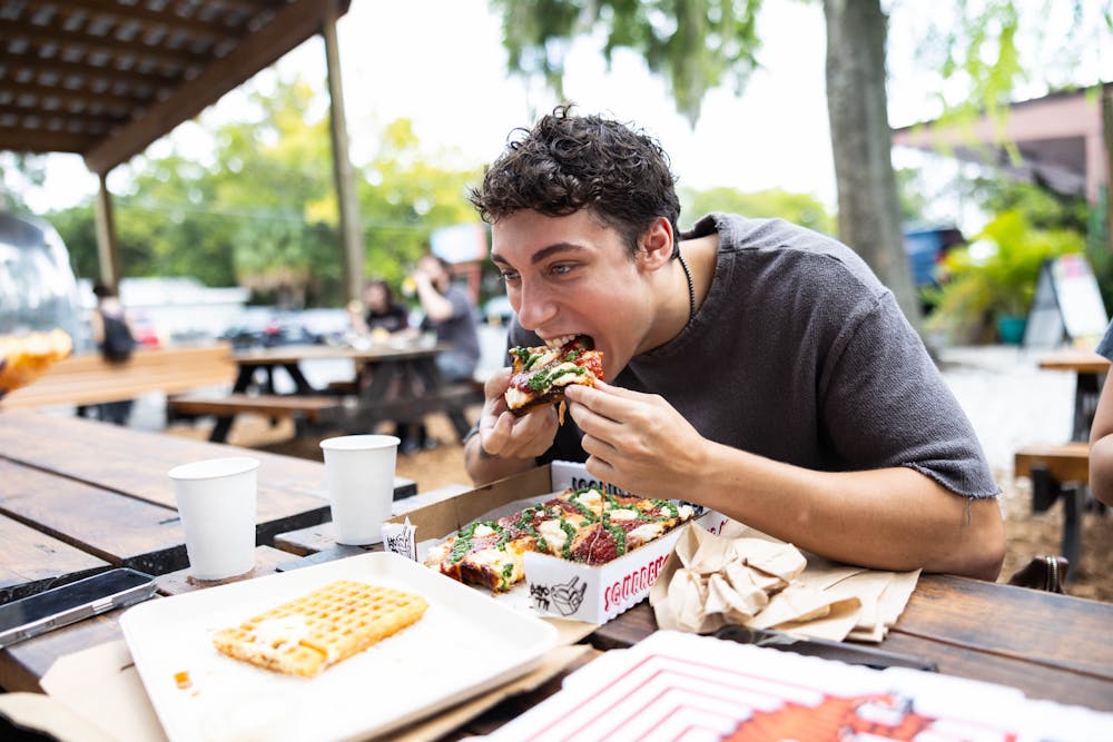 <p>Aidan Ragan enjoys his order from SquareHouse Pizza on Saturday, Aug. 23, 2025.</p><p></p>