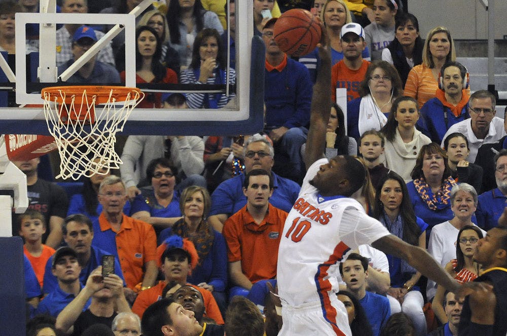 <p>Dorian Finney-Smith dunks during Florida’s win over West Virginia on Jan. 30, 2016, in the O’Connell Center.</p>