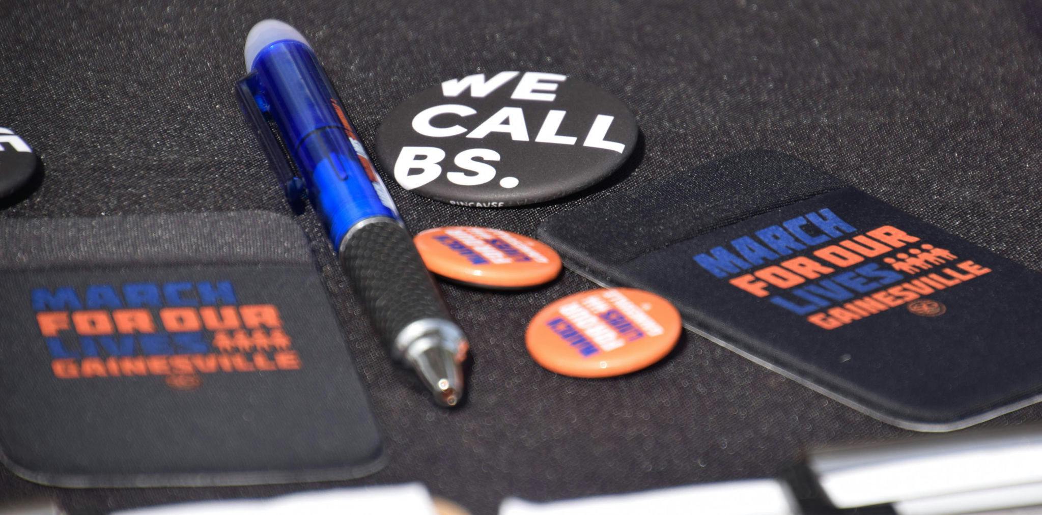 March for Our Lives Gainesville handed out pins, pens and other merchandise to students walking by.
