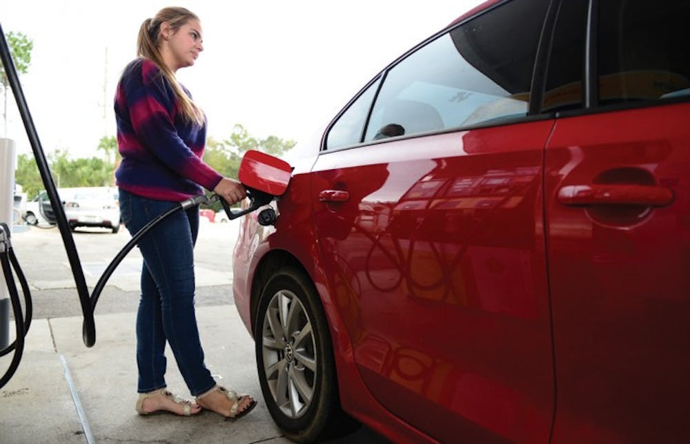 <p>Chantelle Melendez, a 20-year-old psychology junior, pumps gas Tuesday at the Shell station at 3330 SW Archer Road. The average gas price in Florida is $3.43, said Gregg Laskoski, senior petroleum analyst for GasBuddy.com.</p>