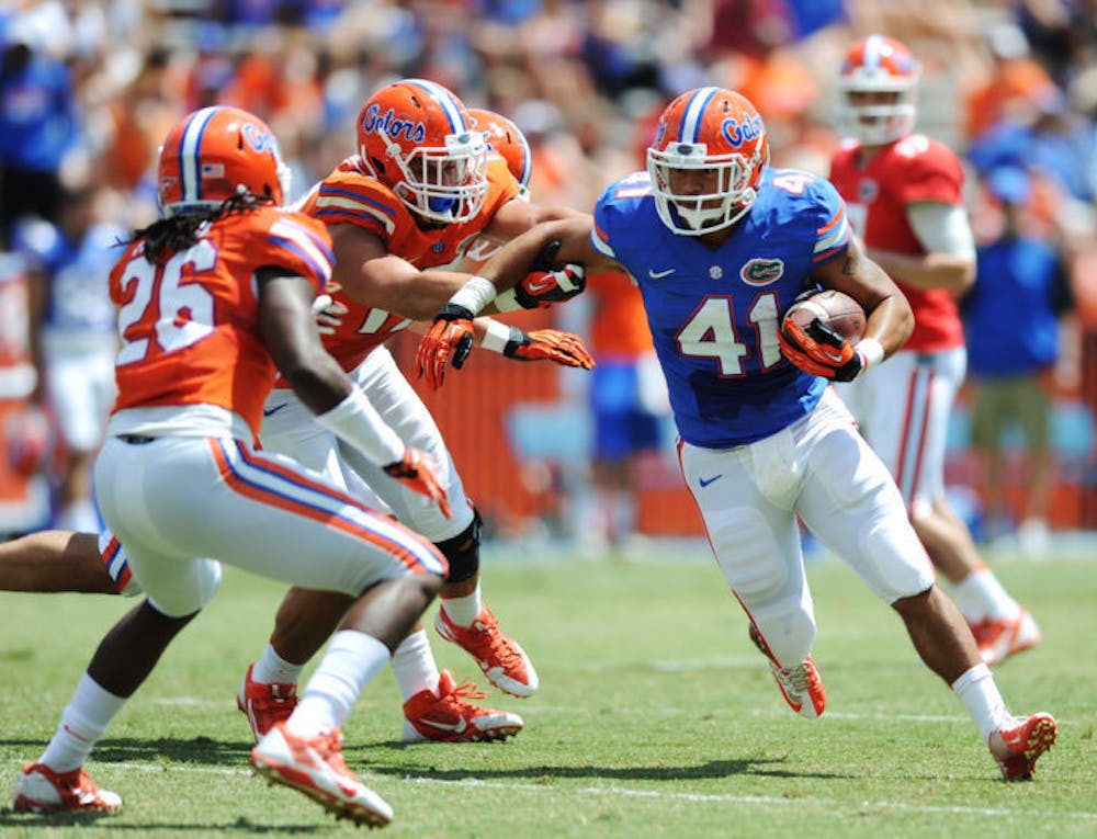 <p>Hunter Joyer (41) runs the ball during Florida’s Orange and Blue Debut on Saturday in Ben Hill Griffin Stadium. The Gators’ two offenses combined for 606 yards in the game.</p>