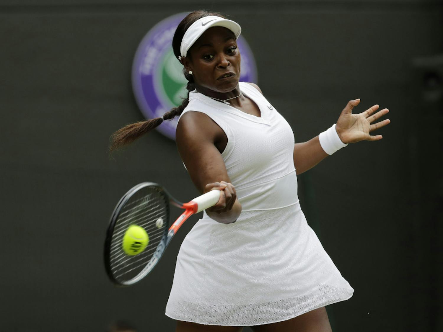 FILE - In this July 6, 2019, file photo, Sloane Stephens returns to Britain's Johanna Konta in a women's singles match at the Wimbledon Tennis Championships in London. Any World TeamTennis player or coach who tests positive for COVID-19 when arriving for the three-week 2020 season will be dropped from the league without pay. The health plan released Tuesday, June 16, 2020, by the WTT for its matches starting July 12 at The Greenbrier in West Virginia also calls for two daily temperature checks for spectators, no ball kids, a chair umpire aided by electronic line-calling instead of line judges, and no high-fives or handshakes between opponents. The rosters announced for the WTT's nine teams include Grand Slam title winners Kim Clijsters, Sloane Stephens, Sofia Kenin and the Bryan brothers. (AP Photo/Ben Curtis, File)