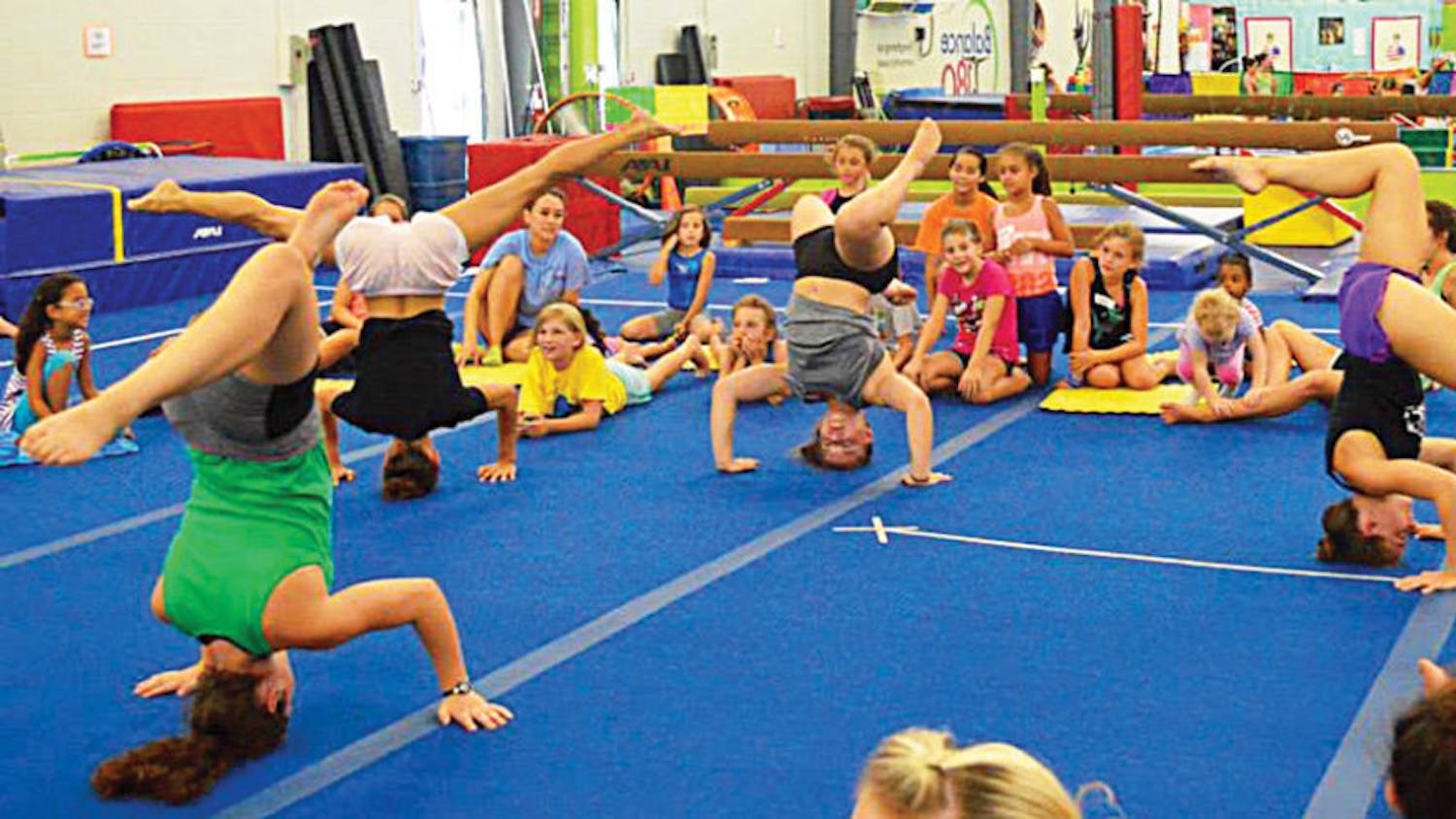 Campers practice headstands at Balance180 Gym during the 2015 gymnastics summer camp.