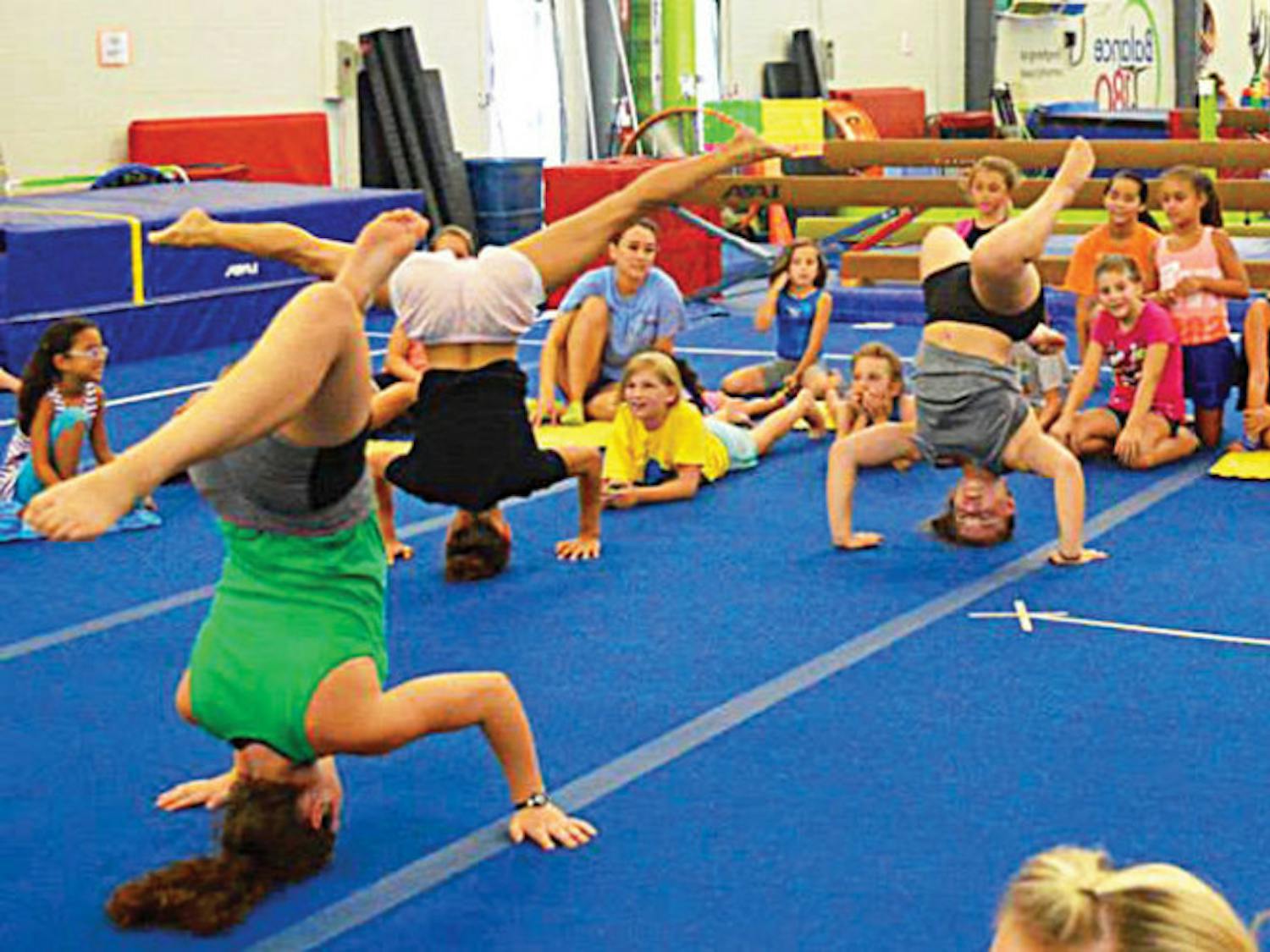 Campers practice headstands at Balance180 Gym during the 2015 gymnastics summer camp.
