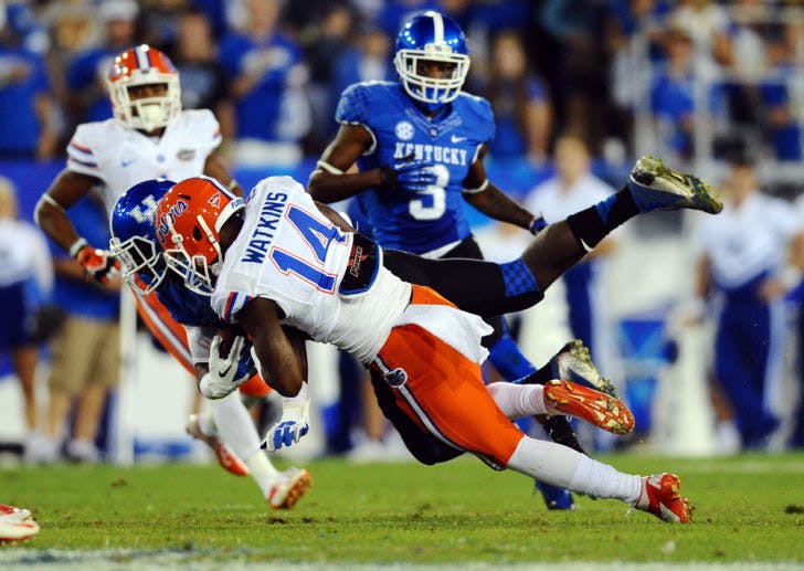 Jaylen Watkins (14) tackles Kentucky wide receiver Alexander Montgomery during the Gators’ 24-7 victory against the Wildcats on Saturday at Commonwealth Stadium.