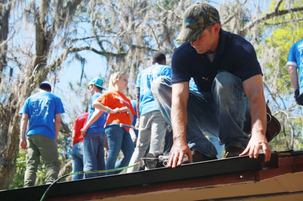 <p class="p1">Students and professors with Rebuilding Together North Central Florida help rebuild a Waldo homeowner’s roof on Thursday. Chanita Ross is a widow and needed the help so she could keep living in her home.</p>