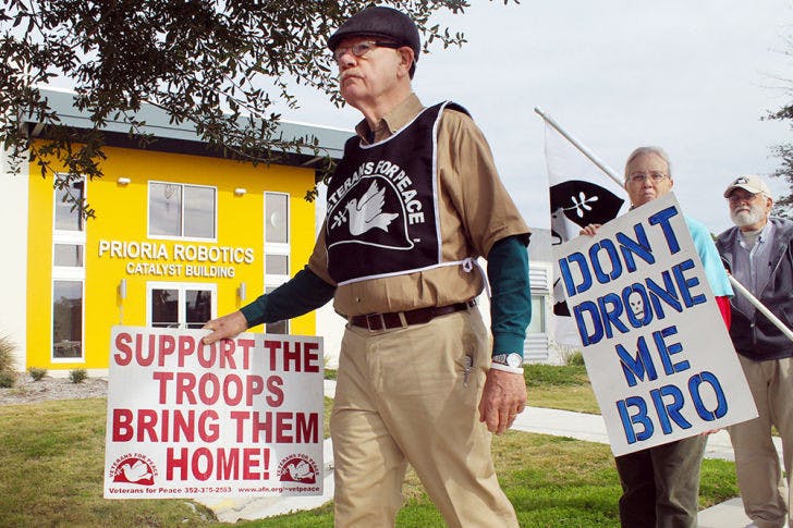 Veterans for Peace Vice President John Fullerton (left), 72, and retired social worker Miriam Elliot, 62, protest Wednesday outside of Prioria Robotics.&nbsp;