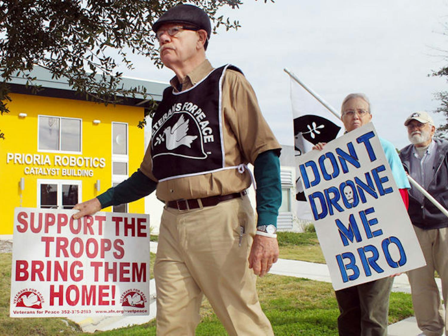 Veterans for Peace Vice President John Fullerton (left), 72, and retired social worker Miriam Elliot, 62, protest Wednesday outside of Prioria Robotics. 