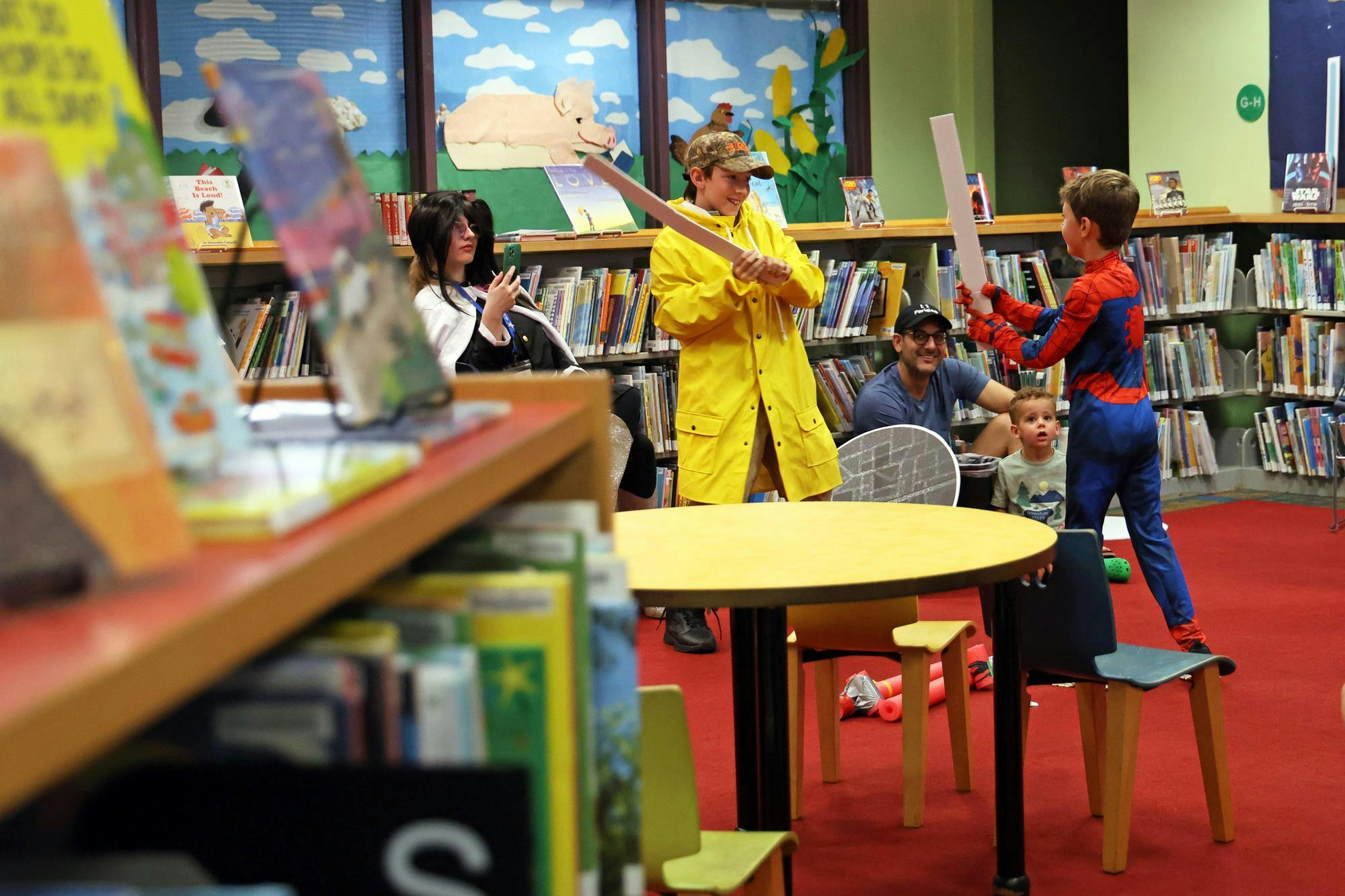 Kids reenact a battle scene from “Star Wars” during Fandomonium at Headquarters Library on Saturday, Sept. 27, 2025.
