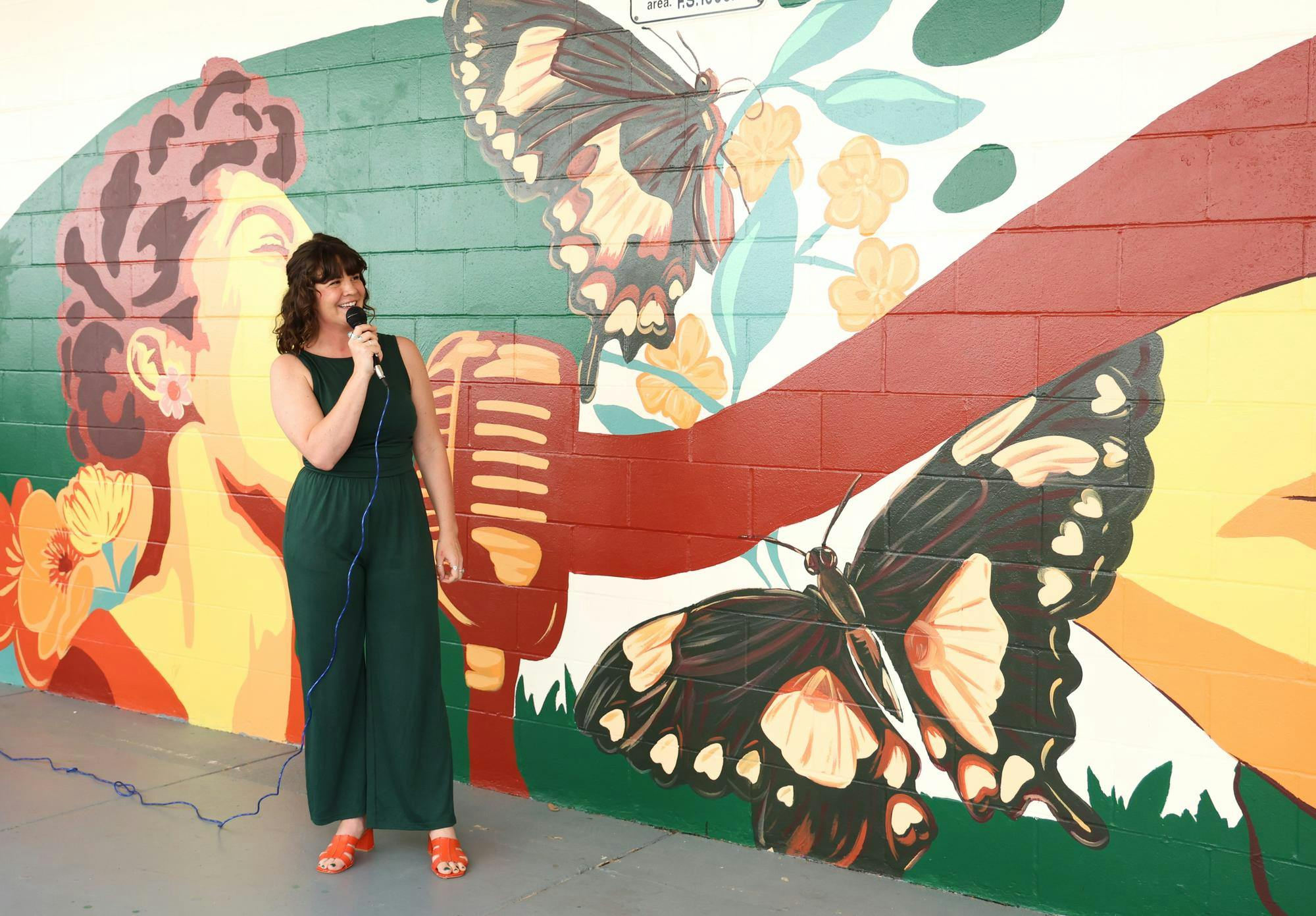 Jenna Horner presents her art and explains the symbolism of the butterflies throughout the mural at Eastside High School Tuesday, March 31, 2026, in Gainesville, Fla.