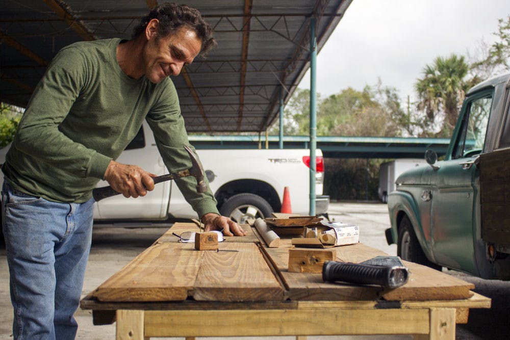 Celino Dimitroff, co-owner of SoMa Art Media Hub, builds a shelving unit out of repurposed wood flooring. Dimitroff said all the shelving will be handmade with mostly salvaged materials in the store he and co-owner Charley McWhorter plan to open in February. "It's sort of breathing a new life into it," he said.