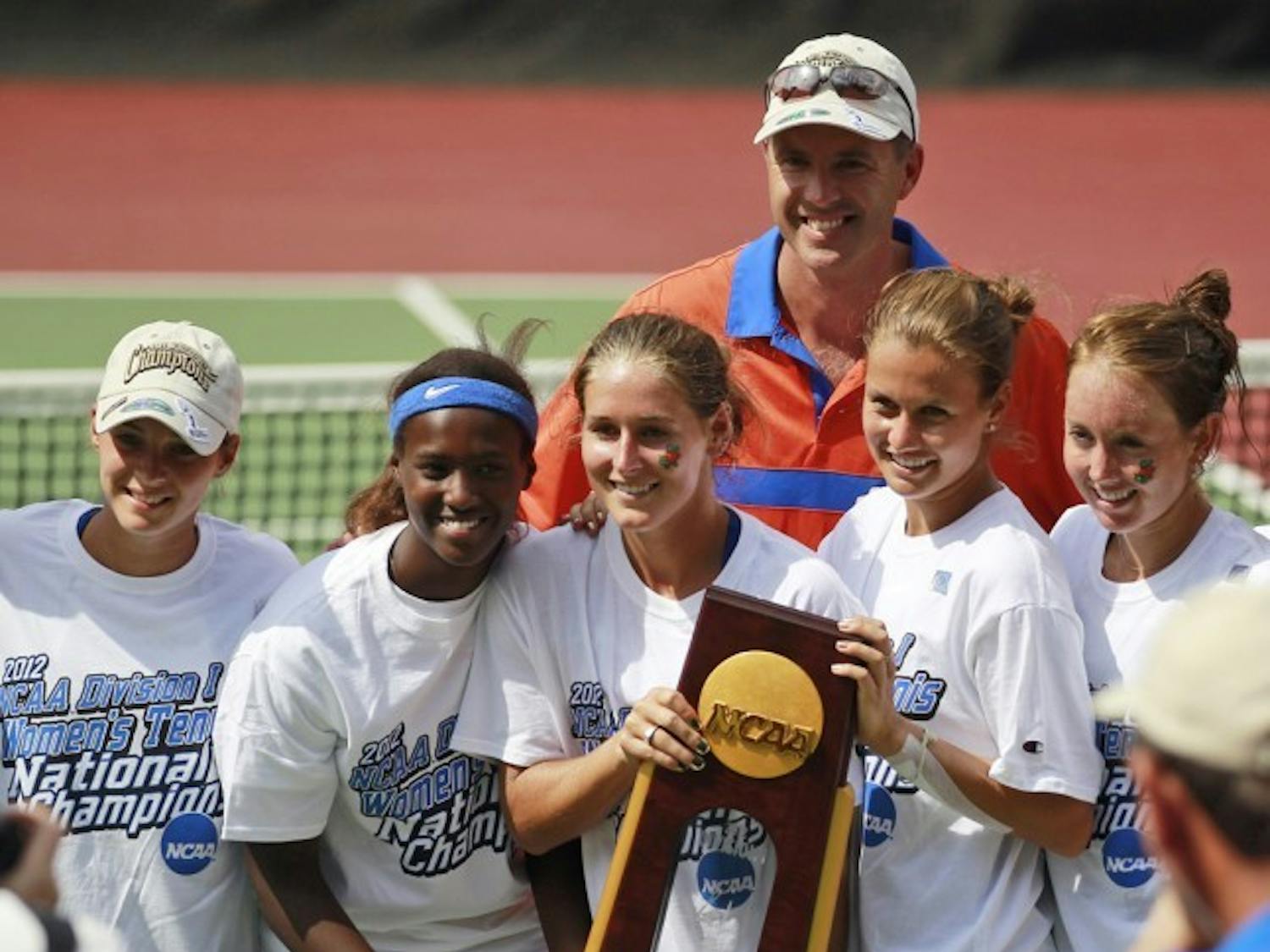 Members of Florida’s women’s tennis team pose with the 2012 NCAA Championship trophy in Athens, Ga., on Tuesday. UF defeated UCLA 4-0 to win its second consecutive national title. 