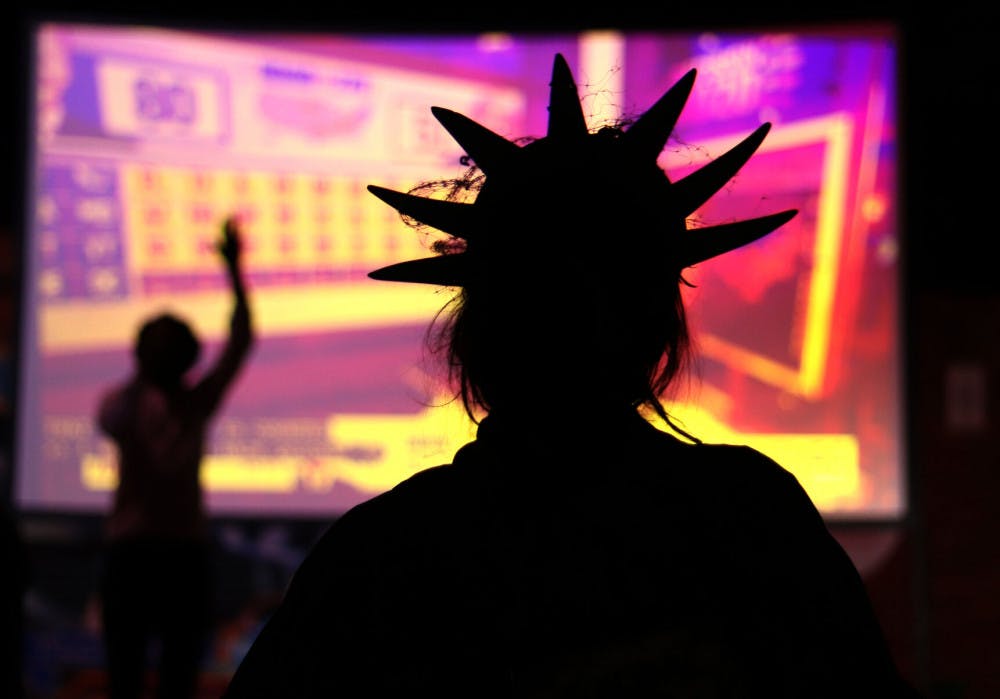 Avenlea Harris is seen dressed as the Statue of Liberty while watching the election results during the Bo Diddley Plaza watch party on Tuesday, Nov. 3, 2020. (Lauren Witte/Alligator Staff)