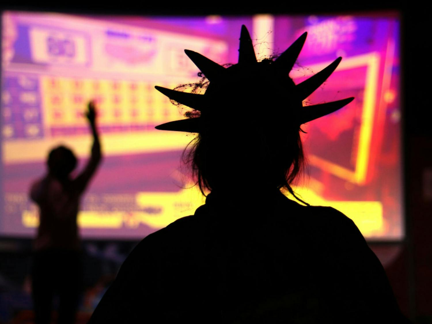 Avenlea Harris is seen dressed as the Statue of Liberty while watching the election results during the Bo Diddley Plaza watch party on Tuesday, Nov. 3, 2020. (Lauren Witte/Alligator Staff)
