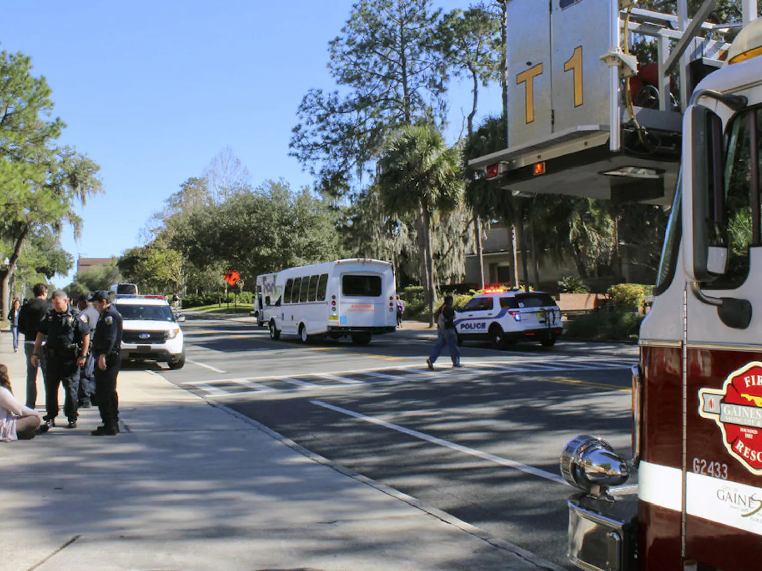 University of Florida Police officers speak to the victim of a bicycle accident on Stadium Road on Monday afternoon. Two hours earlier, a car and a scooter collided on University Avenue.