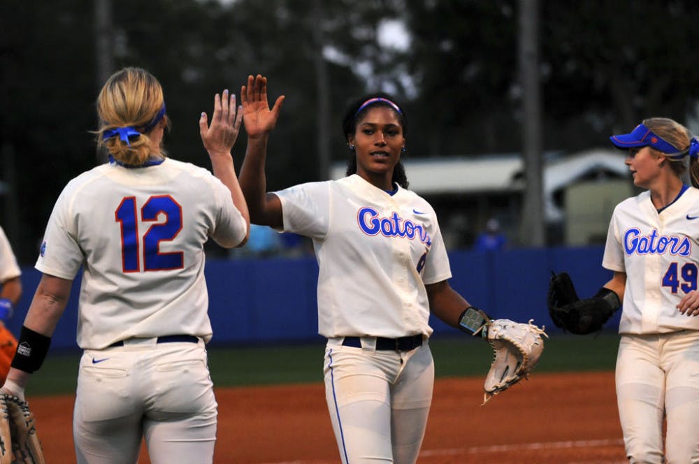 <p>Aleshia Ocasio (middle) high fives a teammate during Florida's doubleheader sweep of Jacksonville on Feb. 17, 2016, at Katie Seashole Pressly Stadium.</p>