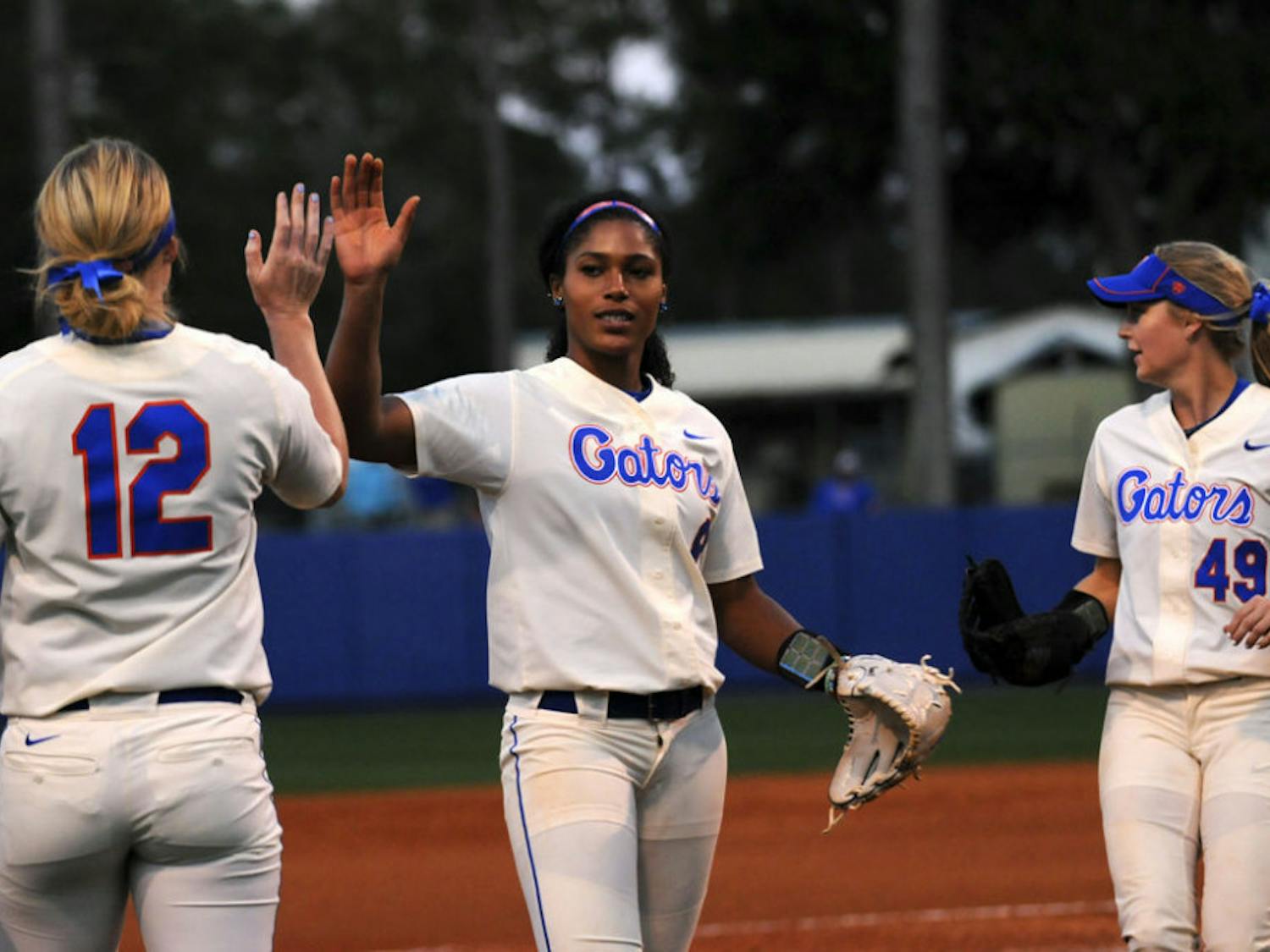 Aleshia Ocasio (middle) high fives a teammate during Florida's doubleheader sweep of Jacksonville on Feb. 17, 2016, at Katie Seashole Pressly Stadium.
