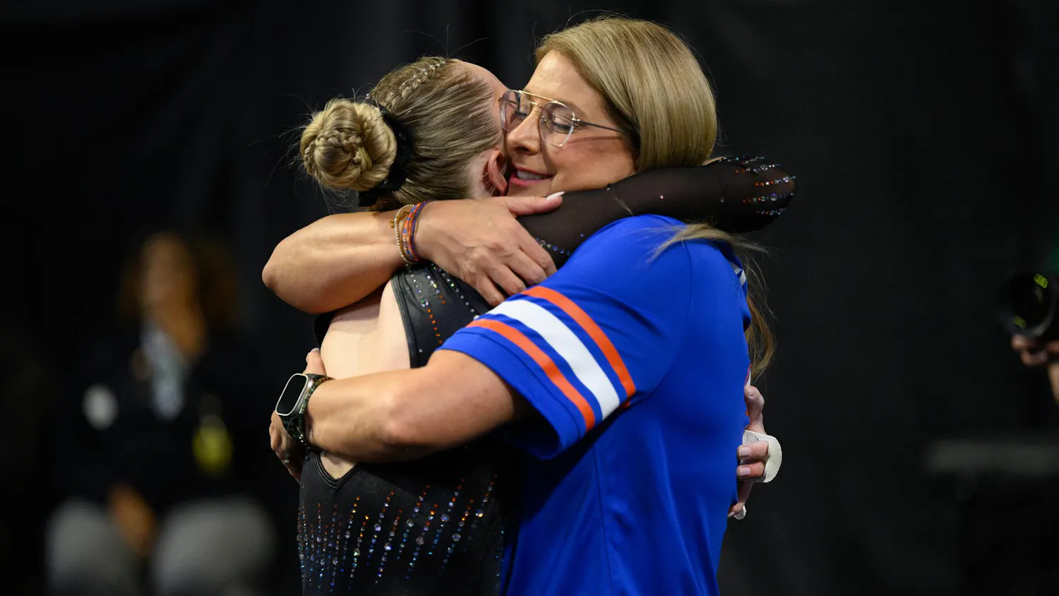 Florida head coach Jenny Rowland hugs gymnast Riley McCusker after her bars routine during the NCAA gymnastics National Championship against Oklahoma, LSU and Minnesota, Saturday, April 18, 2026, in Fort Worth, Texas.