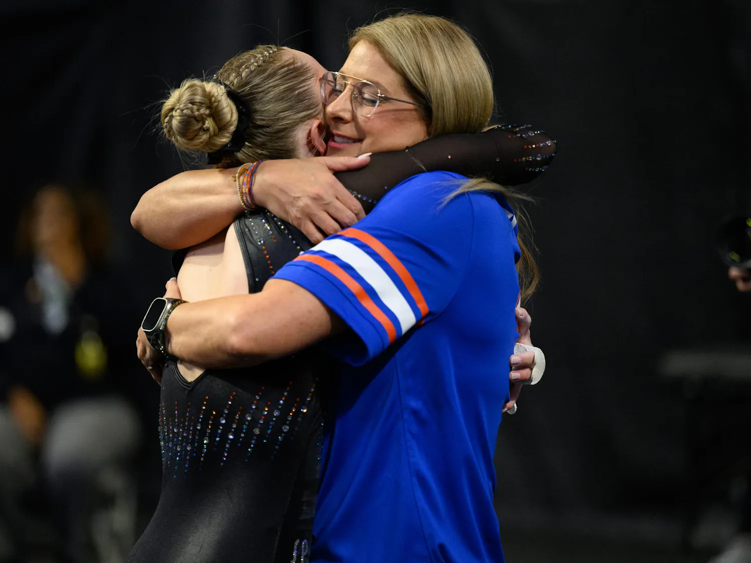 Florida head coach Jenny Rowland hugs gymnast Riley McCusker after her bars routine during the NCAA gymnastics National Championship against Oklahoma, LSU and Minnesota, Saturday, April 18, 2026, in Fort Worth, Texas.