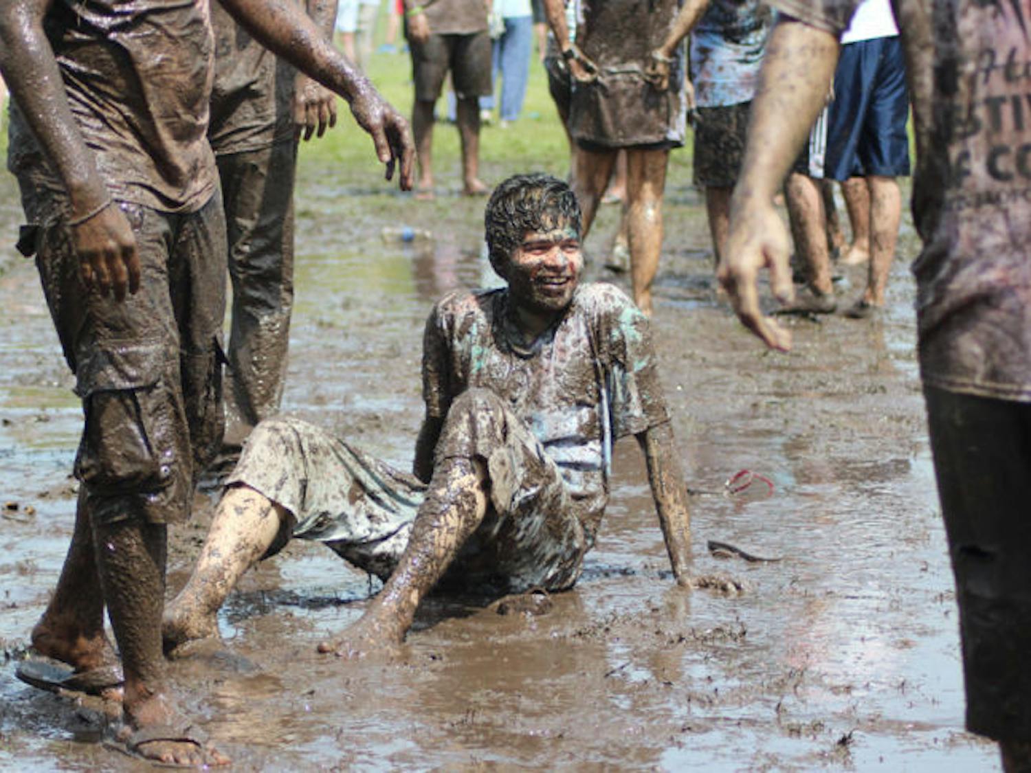 Parag Oke, a 22-year-old UF computer science graduate student, sits in the mud at the UF Holi Festival of Colors on Saturday afternoon. Holi is meant to bring people together from all walks of life and dismiss barriers to equality.