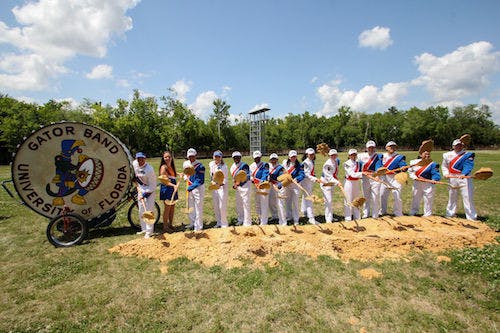 Gator Band members toss dirt to break ground for the new Gator Marching Practice Facility on April 13.
