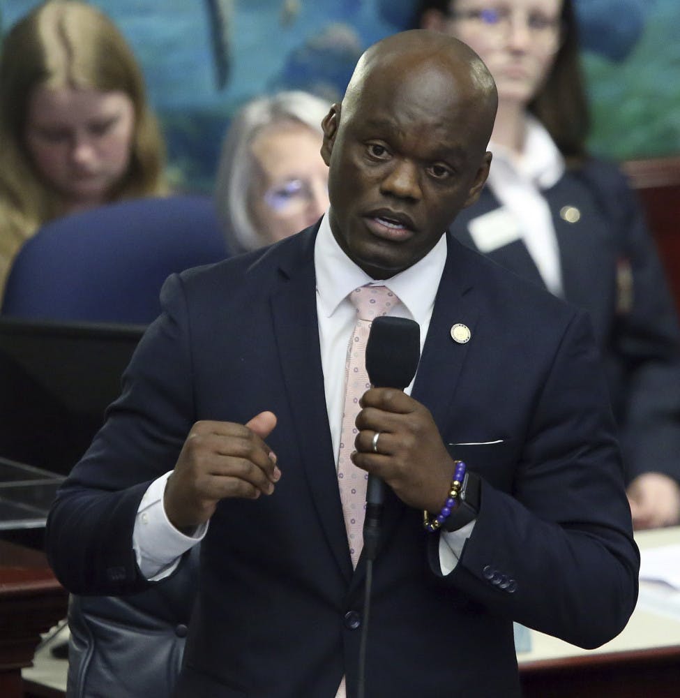 FILE - In this Wednesday April 24, 2019 file photo, Rep. Kionne McGhee, D-Miami, debates the felon voting rights bill during session in Tallahassee, Fla. Following California's lead, Florida lawmakers are tackling NCAA rules that prohibit college athletes from reaping financial benefits from their prowess in the arena of big-money sports. A proposal by state House Democratic Leader Kionne McGhee is modeled after one signed into law last month by California Gov. Gavin Newsom that allows college athletes in the Golden State to sign endorsement deals and hire agents without endangering scholarships and their eligibility to participate in NCAA-sanctioned sports. (AP Photo/Steve Cannon, File)