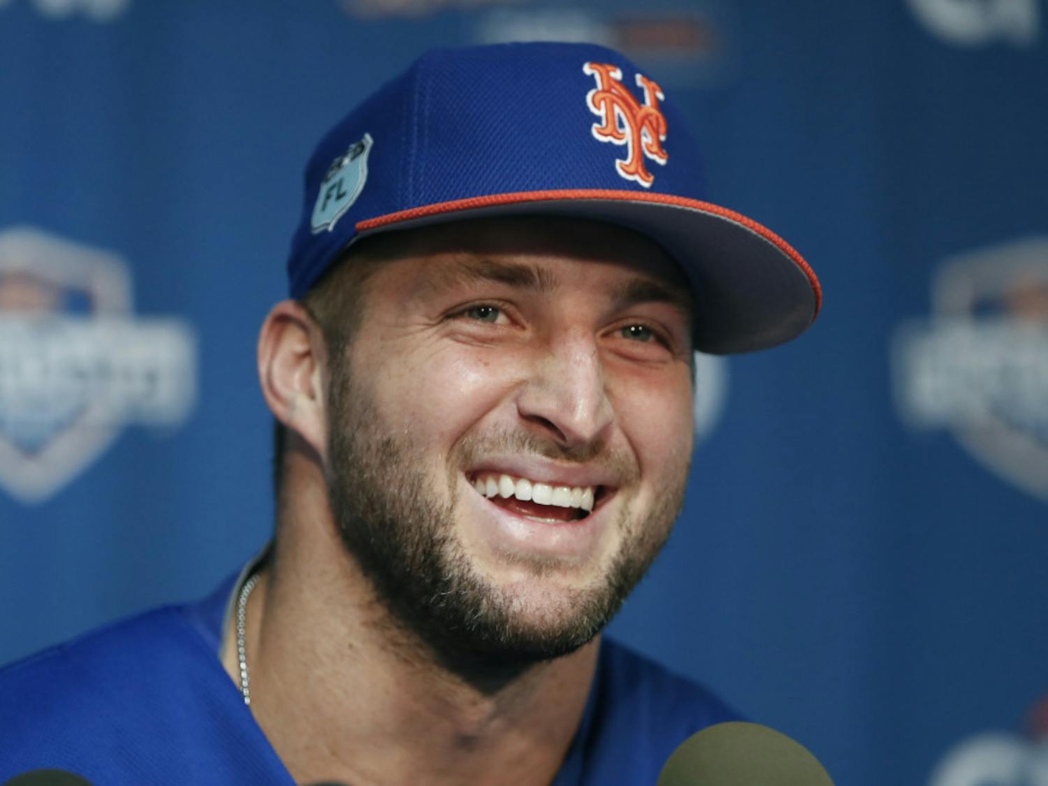 New York Mets outfielder and former NFL quarterback Tim Tebow laughs during a news conference at the baseball teams spring training facility in Port St. Lucie, Fla., Monday, Feb. 27, 2017. (AP Photo/John Bazemore)