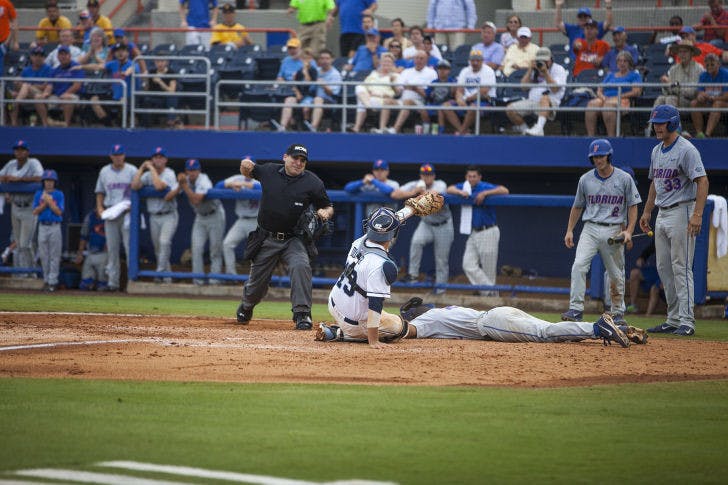 UF shortstop Richie Martin is tagged out at home plate by UNC catcher Korey Dunbar during Florida's 5-2 loss on Saturday at McKethan Stadium. The loss eliminated the Gators from the NCAA Tournament.