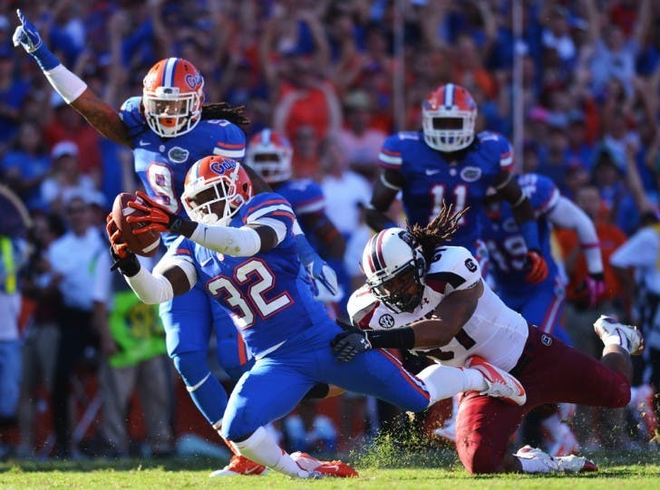 With Josh Evans (9) looking on in celebration, Chris Johnson reaches for the end zone after recovering a fumble in the second quarter of Florida’s 44-11 win against South Carolina on Saturday at Ben Hill Griffin Stadium.
