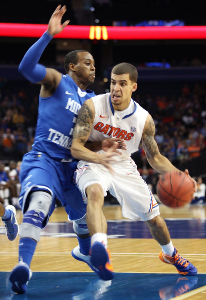 Guard Scottie Wilbekin (5) drives against Middle Tennessee in UF’s 66-45 win on Nov. 18 in Tampa.  
