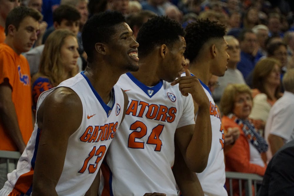 <p>Kevarrius Hayes, left, and Justin Leon watch from the sideline during Florida's 95-63 win over Auburn on Jan. 23, 2016, in the O'Connell Center.</p>