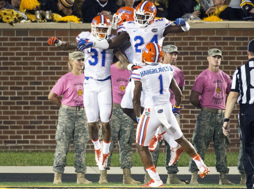 <p>Florida defensive back Jalen Tabor, left, celebrates with teammates after he returned an interception for a touchdown during the second half of an NCAA college football game against Missouri, on Oct. 10 2015, in Columbia, Missouri.</p>