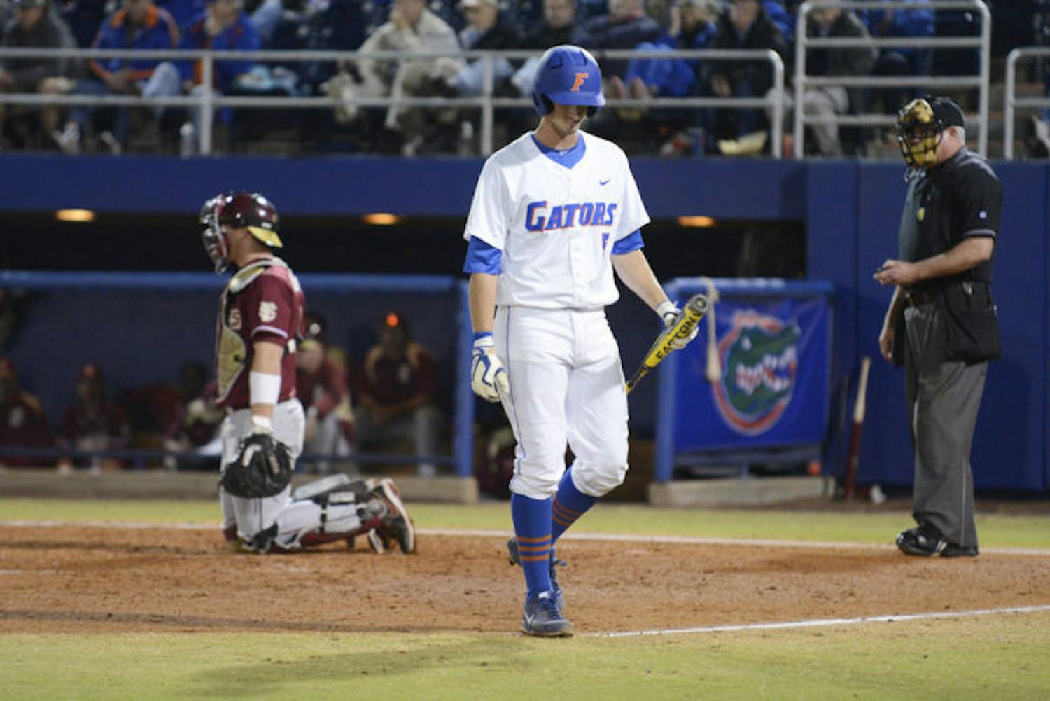 Zack Powers walks back to the dugout after striking out during Florida’s 4-1 loss to Florida State on March 12, 2013 at McKethan Stadium.&nbsp;