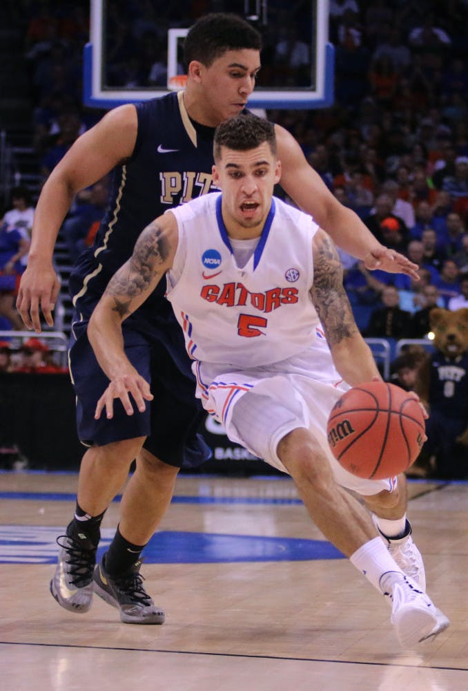 Scottie Wilbekin drives the lane Saturday in Florida's 61-45 victory over Pitt.