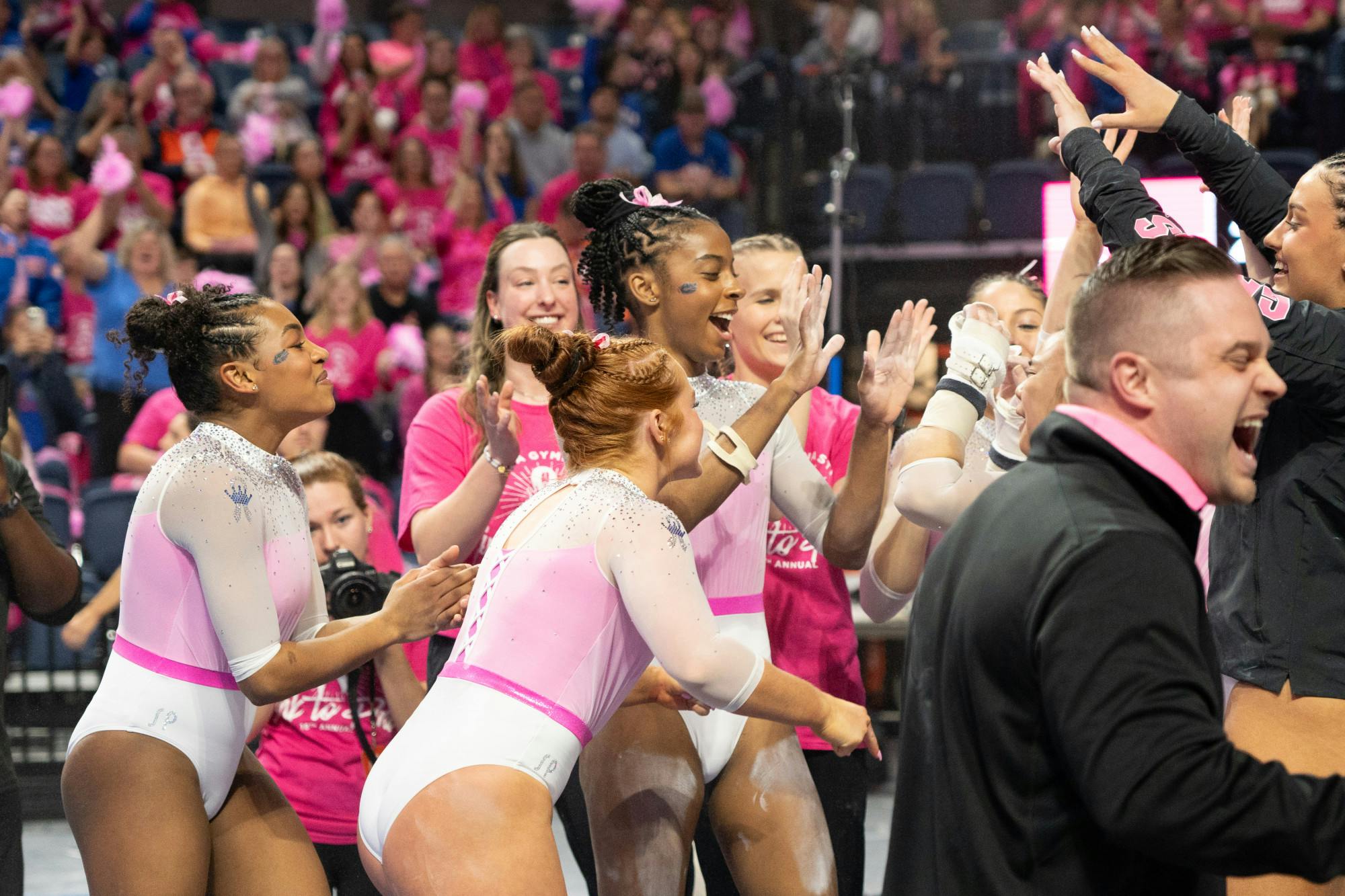 The Florida Gators gymnastics team celebrates its 197.85-196.05 win over the Arkansas Razorbacks, Friday, Feb. 9, 2024. 