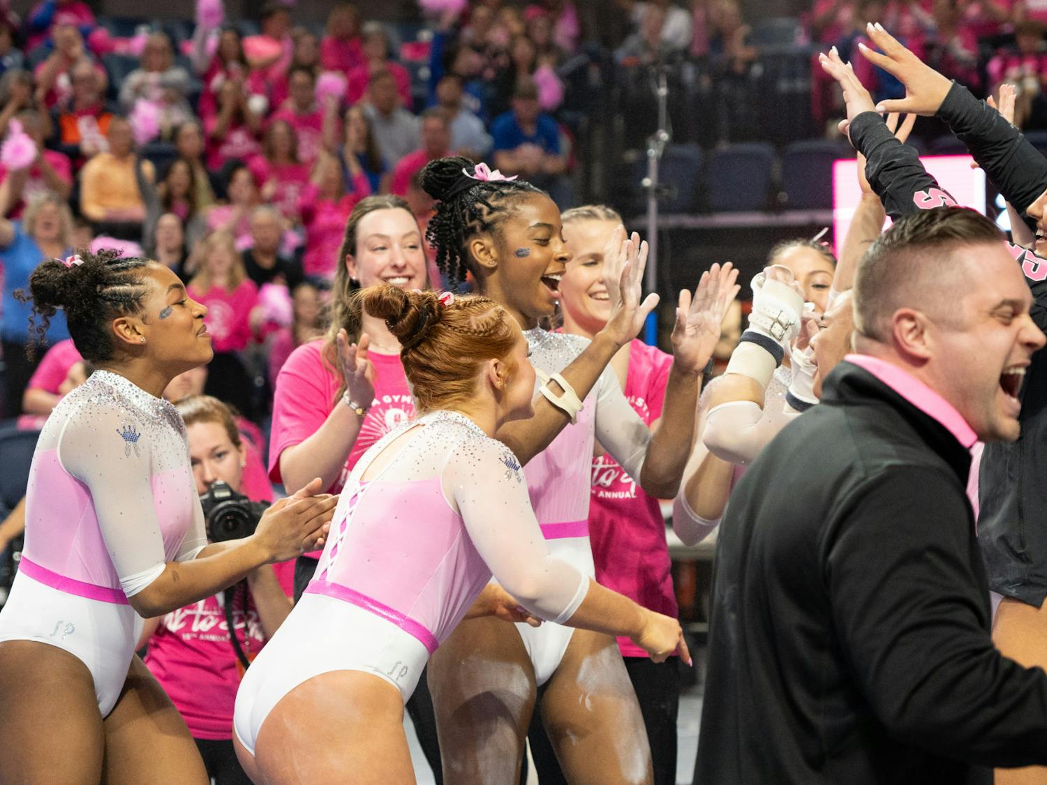 The Florida Gators gymnastics team celebrates its 197.85-196.05 win over the Arkansas Razorbacks, Friday, Feb. 9, 2024.