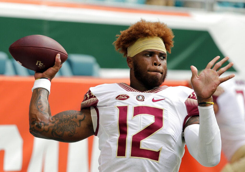 FILE - In this Saturday, Oct. 6, 2018, file photo, Florida State quarterback Deondre Francois (12) warms up before an NCAA college football game against Miami, in Miami Gardens, Fla. Florida State head football coach Willie Taggart announced Sunday, Feb. 3, 2019, that Francois has been dismissed from the team after allegations of domestic abuse surfaced. (AP Photo/Lynne Sladky, File)