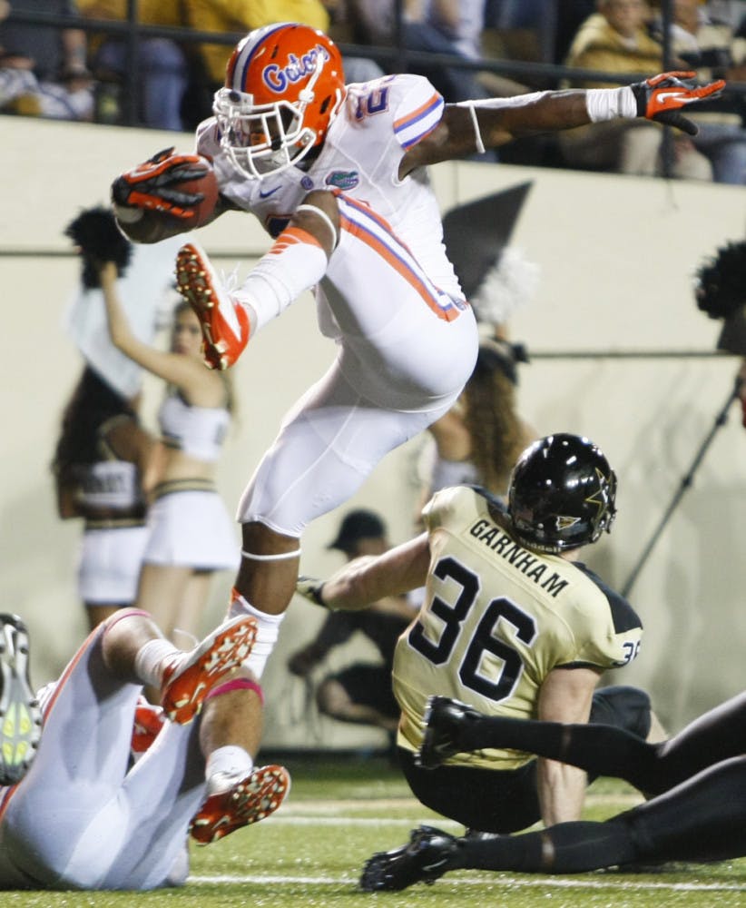 Senior running back Mike Gillislee attempts to hurdle over a Vanderbilt defender during Florida's 31-17 win against Vanderbilt in Nashville, Tenn. Gillislee leads Southeastern Conference running backs in rushing yardage. South Carolina running back Marcus Lattimore tops the conference in rushing attempts with 129.