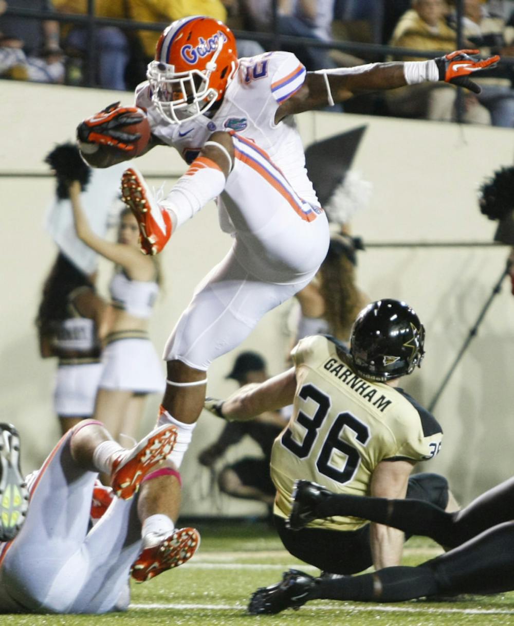 <p>Senior running back Mike Gillislee attempts to hurdle over a Vanderbilt defender during Florida's 31-17 win against Vanderbilt in Nashville, Tenn. Gillislee leads Southeastern Conference running backs in rushing yardage. South Carolina running back Marcus Lattimore tops the conference in rushing attempts with 129.</p>