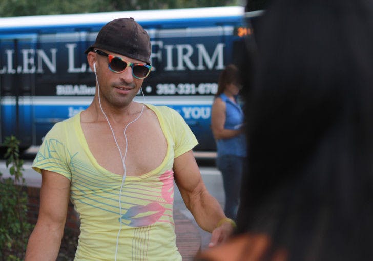 Dennis Kane, the Turlington Dancer, talks to a student on the southeast corner of West University Avenue and Buckman Drive on Sept. 19. Kane is trespassed from UF campus until 2015.