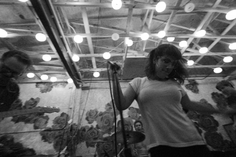 <p>Chick-fil-atio singer Amanda Gonzales rocks out on stage at Boca Fiesta on Saturday night during Band Roulette. During their set, the band handed out free T-shirts printed with their logo.</p>