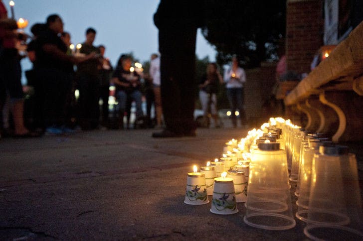The Reverend William H. Russell Jr., 51, from The United New Testament Church International speaks at a candlelight vigil held for missing Christian Aguilar on the corner of Southwest 13th Street and West University Avenue Thursday evening. Christian Aguilar went missing on Sept. 20, Pedro Bravo, the main suspect in the disappearance was indicted with murder and kidnapping charges on Monday.