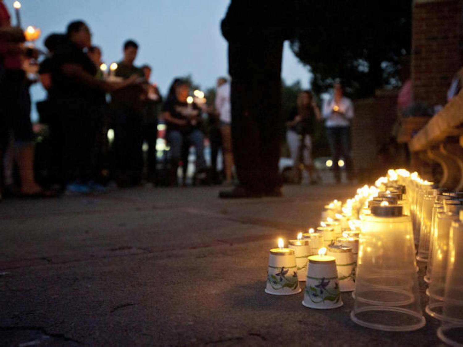 The Reverend William H. Russell Jr., 51, from The United New Testament Church International speaks at a candlelight vigil held for missing Christian Aguilar on the corner of Southwest 13th Street and West University Avenue Thursday evening. Christian Aguilar went missing on Sept. 20, Pedro Bravo, the main suspect in the disappearance was indicted with murder and kidnapping charges on Monday.