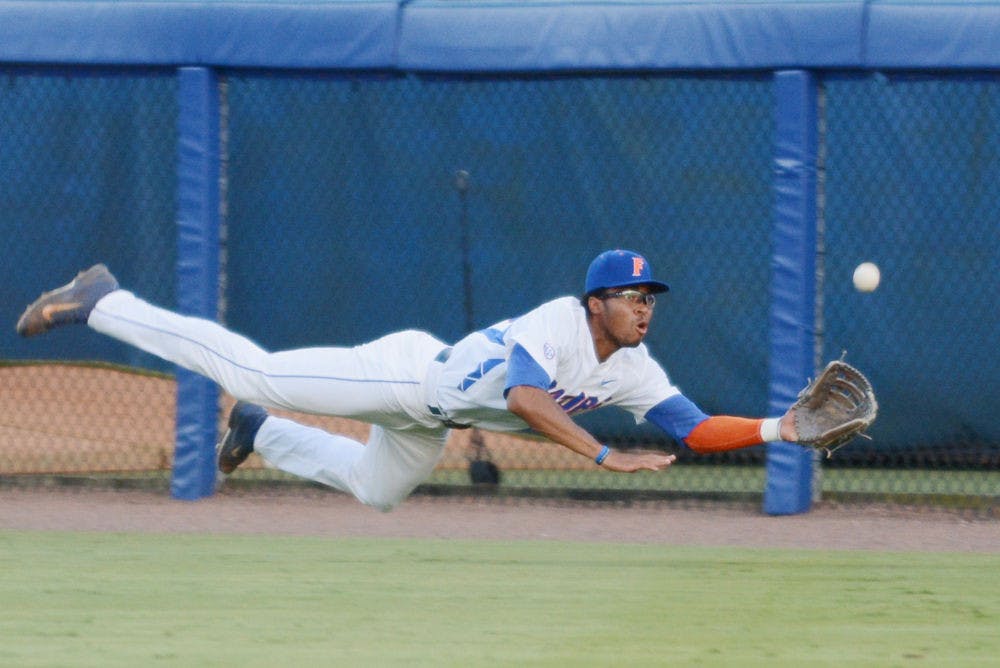 UF outfielder Buddy Reed dives for a catch during Florida's win against Florida A&amp;M in the 2015 NCAA Regionals at McKethan Stadium.