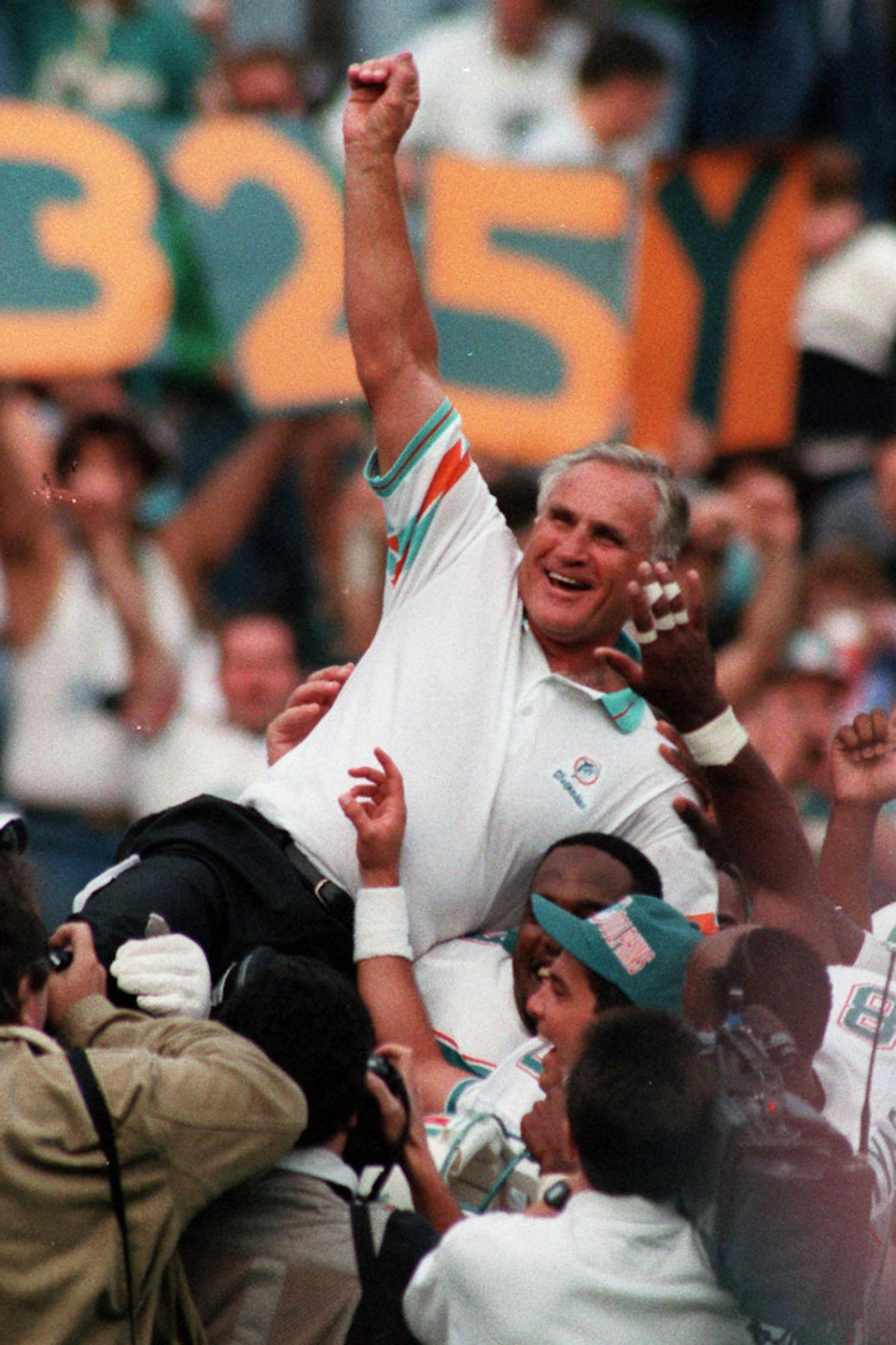 FILE - In this Nov. 14, 1993, file photo, Miami Dolphins coach Don Shula is carried on his team's shoulders after his 325th victory, at Philadelphia's Veterans Stadium. Shula, who won the most games of any NFL coach and led the Miami Dolphins to the only perfect season in league history, died Monday, May 4, 2020, at his home in Indian Creek, Fla., the team said. He was 90. (AP Photo/Amy Sancetta, File)