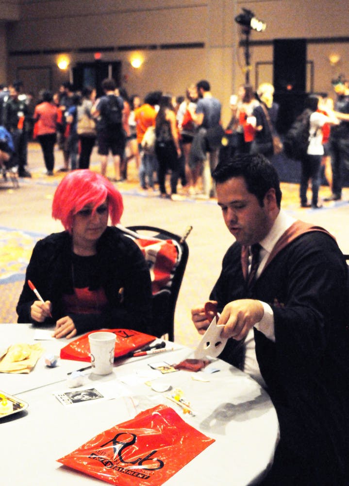 UF psychology senior Tiffany Dawson, 21, designs masks with Gus Laguna, 21, as part of a Harry Potter-themed activity in the Reitz Union Thursday.