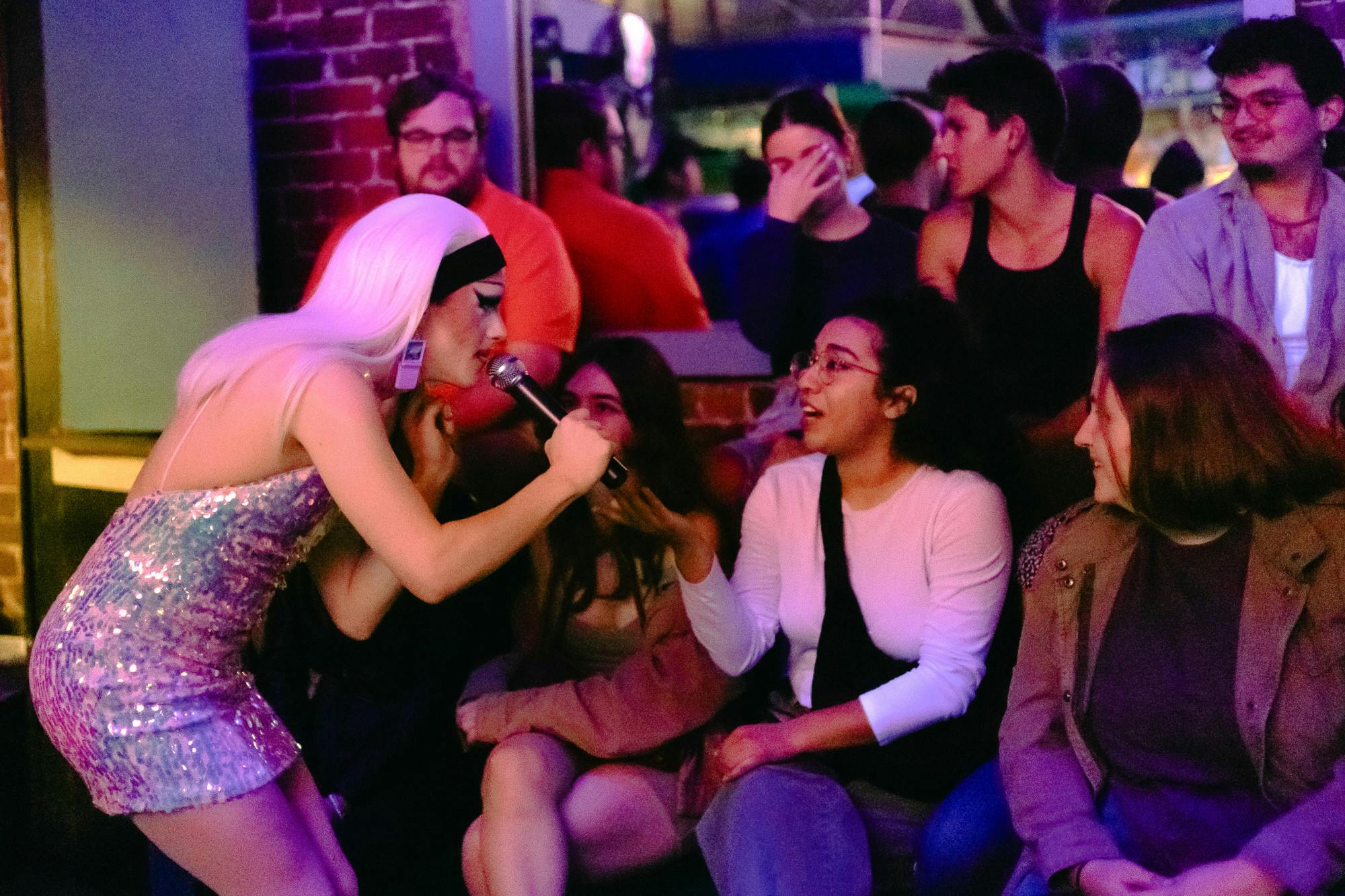 Local drag queen Inertia talks to audience members at a RuPaul’s Drag Race viewing event at University Club on Friday, Feb. 2, 2024.