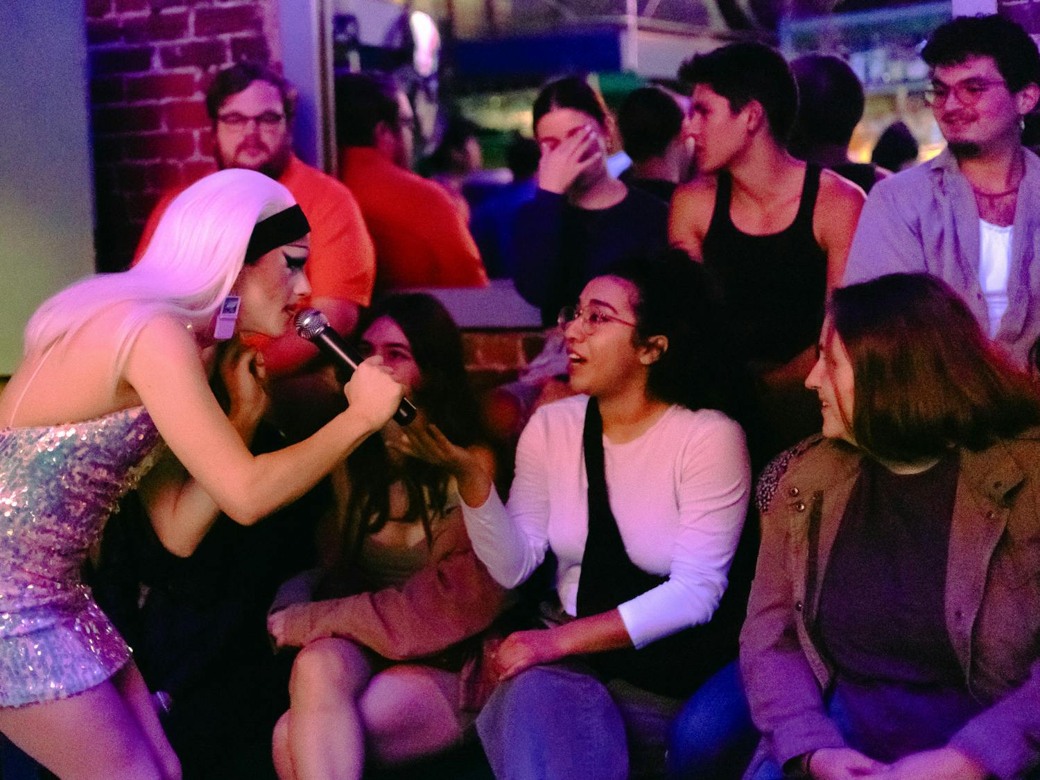 Local drag queen Inertia talks to audience members at a RuPaul’s Drag Race viewing event at University Club on Friday, Feb. 2, 2024.