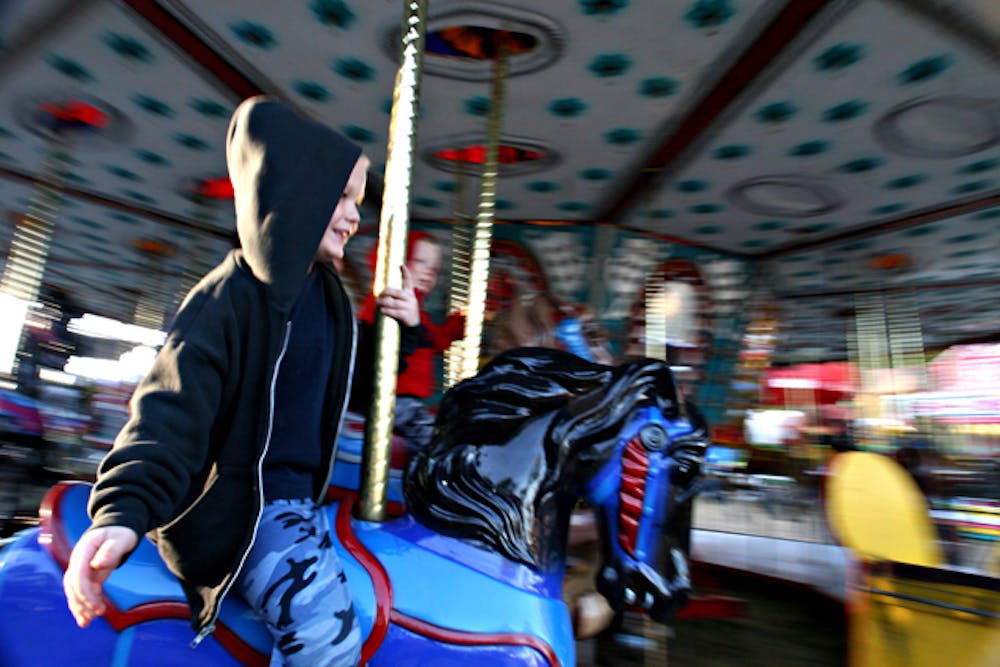 <p>&nbsp;</p>
<p style="margin-bottom: 0in;"><a name="__DdeLink__85_2036580917"></a>A young boy rides the carousel at the Alachua County Fair in 2006. The fair, which was canceled in 2010 for the first time in 40 years due to financial problems, has paid its debts and will open its gates once more in October.</p>