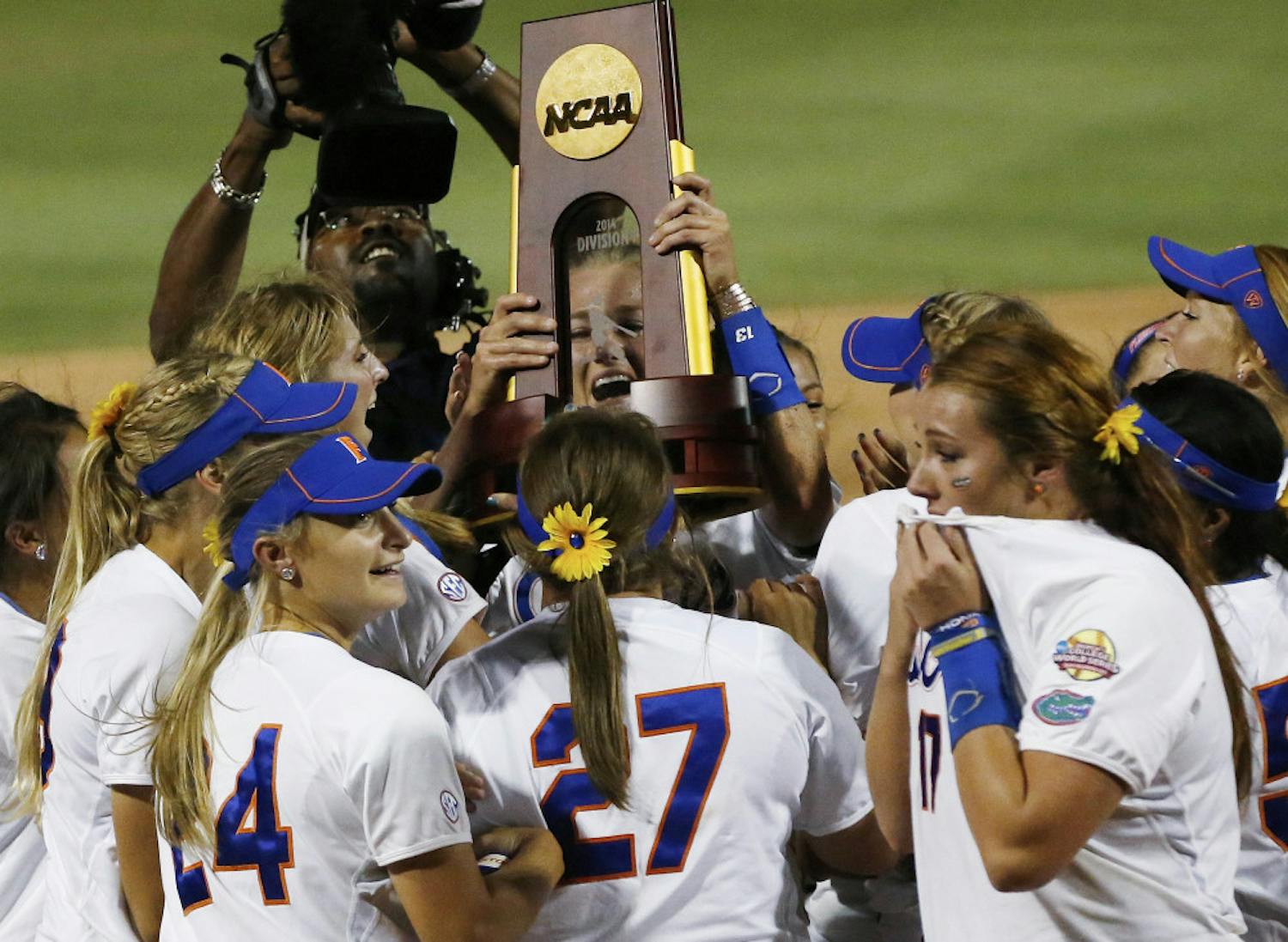 Hannah Rogers holds the trophy as the Gators celebrate their first NCAA championship after defeating Alabama 6-3 in Oklahoma City, Okla., on June 3. Florida sweeped the final series in two games.